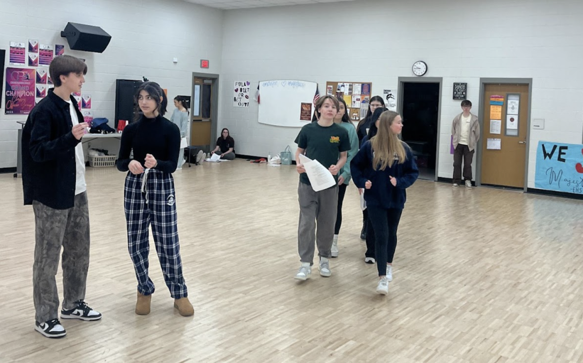 Cast members Jaxan Preston 10, KK Kennedy 10, Channing Parkman 10 and Patrick Kuypers 11 practice their choreography in preparation for the show.